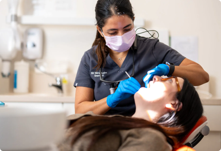 Dr Niru providing dental treatment at Providence Dental